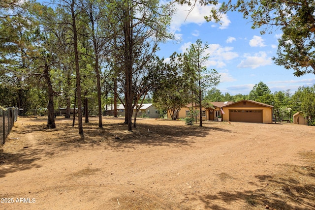 3384 Turkey Run, Overgaard, AZ 85933 - view of front of house featuring driveway, a garage, and a storage shed