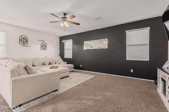 carpeted living room featuring ceiling fan