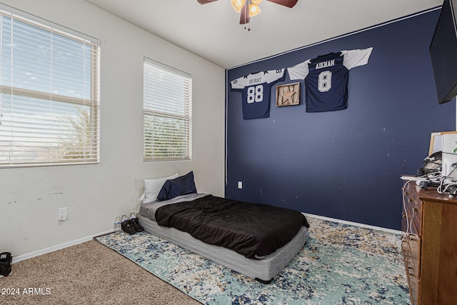 bedroom with ceiling fan, multiple windows, and carpet floors