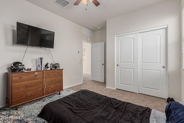 carpeted bedroom with a closet and ceiling fan