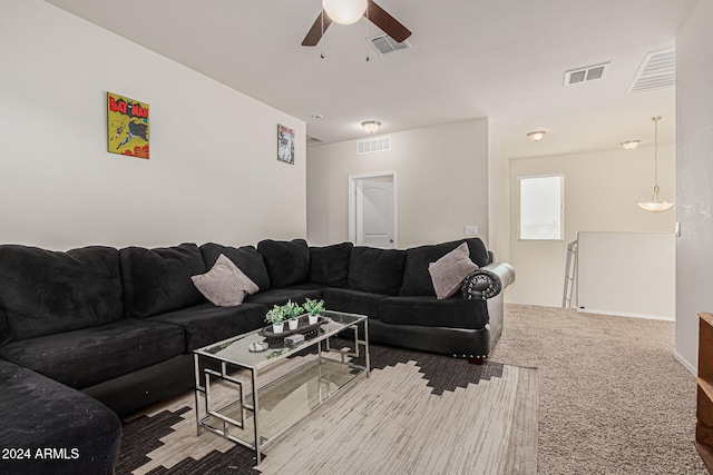 carpeted living room with ceiling fan