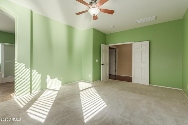 unfurnished bedroom featuring ceiling fan and light carpet