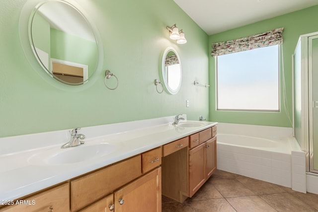 bathroom featuring vanity, tile patterned flooring, and a relaxing tiled tub