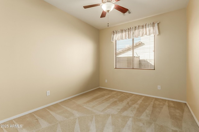 carpeted spare room featuring ceiling fan