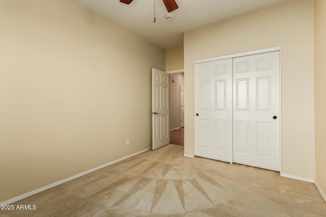 unfurnished bedroom featuring light carpet, a closet, and ceiling fan