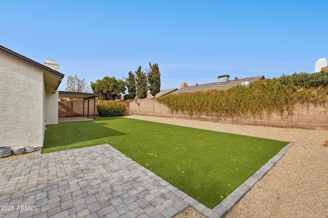 view of yard featuring a patio area and a fenced backyard