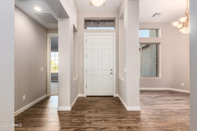 entrance foyer featuring a notable chandelier and dark hardwood / wood-style flooring