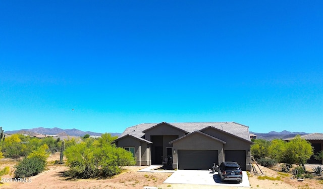 view of front of house with a mountain view and a garage