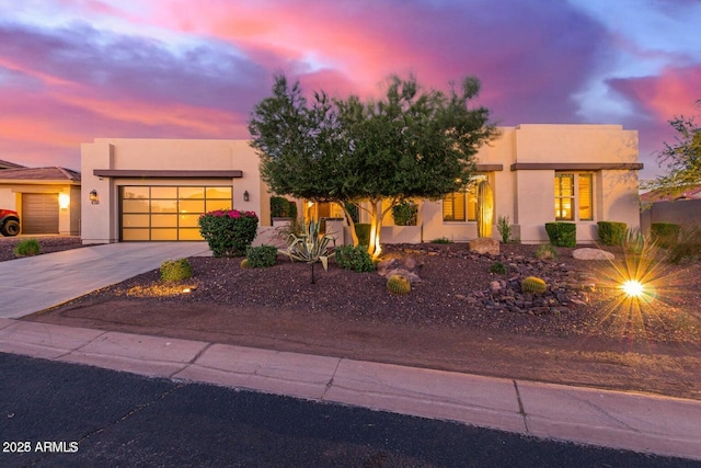 30271 N 117th Dr, Peoria, AZ 85383 - pueblo-style house with stucco siding, concrete driveway, and a garage