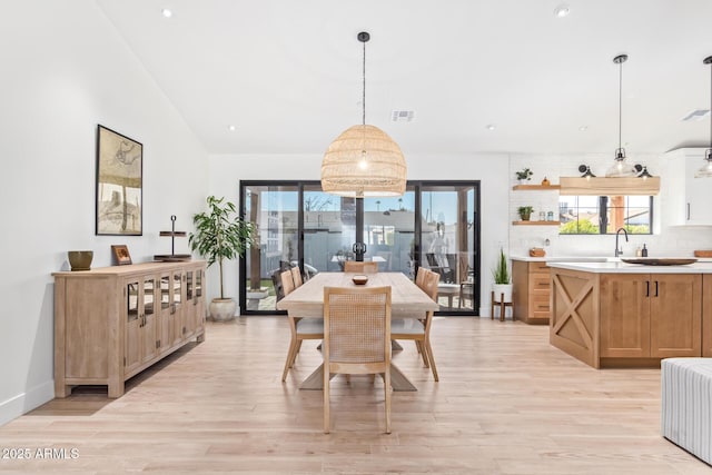 dining room featuring light wood-type flooring, lofted ceiling, visible vents, and recessed lighting