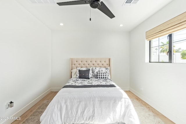 bedroom with baseboards, light wood-type flooring, visible vents, and recessed lighting