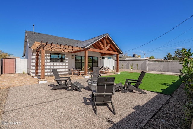 view of patio with an outdoor fire pit, a pergola, and a fenced backyard