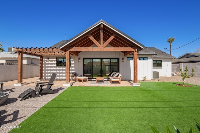 back of house with a fenced backyard, central AC, and board and batten siding