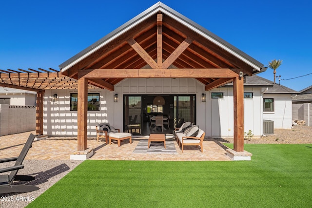 back of property with a patio, a lawn, central AC unit, board and batten siding, and fence