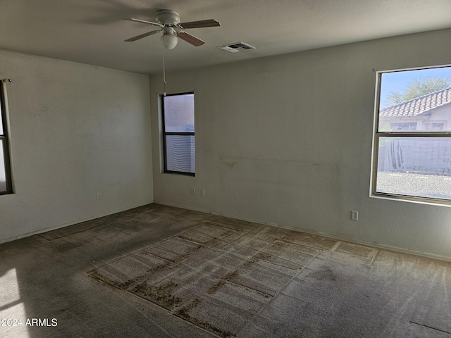 carpeted empty room featuring ceiling fan