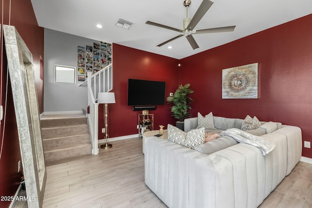 living room featuring light hardwood / wood-style floors and ceiling fan