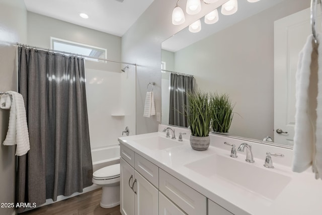 full bathroom featuring shower / tub combo, vanity, hardwood / wood-style floors, and toilet