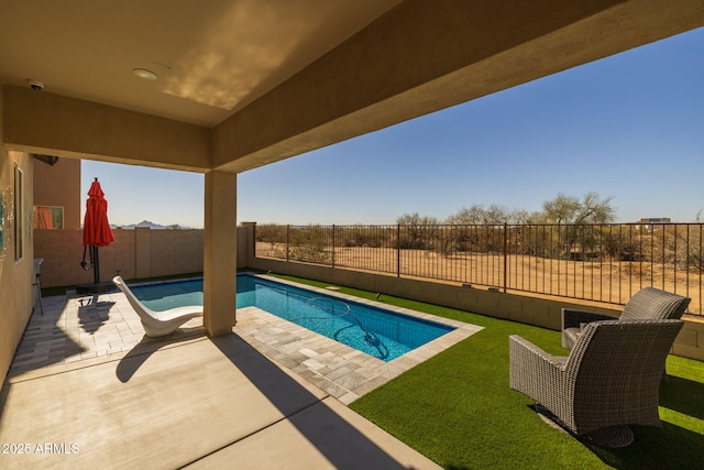 view of pool with a patio and a lawn