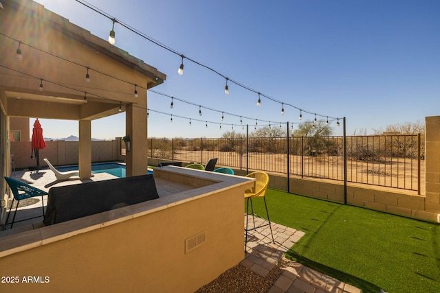 view of patio featuring exterior bar and a fenced in pool