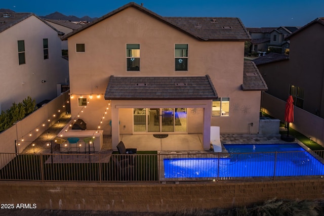 back of house featuring a fenced in pool and a patio area