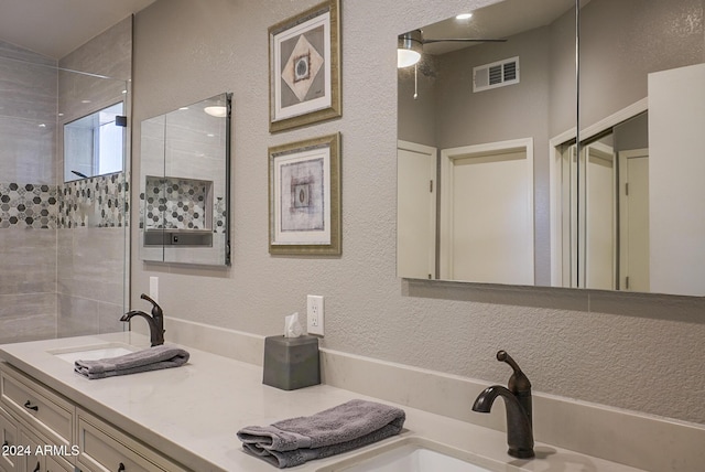 bathroom featuring vanity and tiled shower