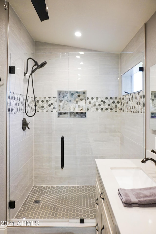 bathroom featuring walk in shower and vanity