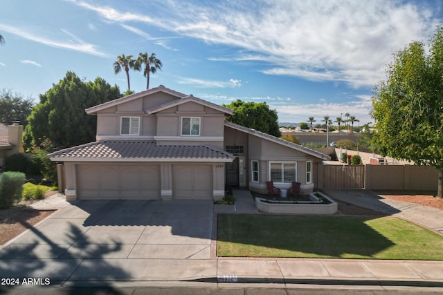 view of front of property with a garage and a front lawn