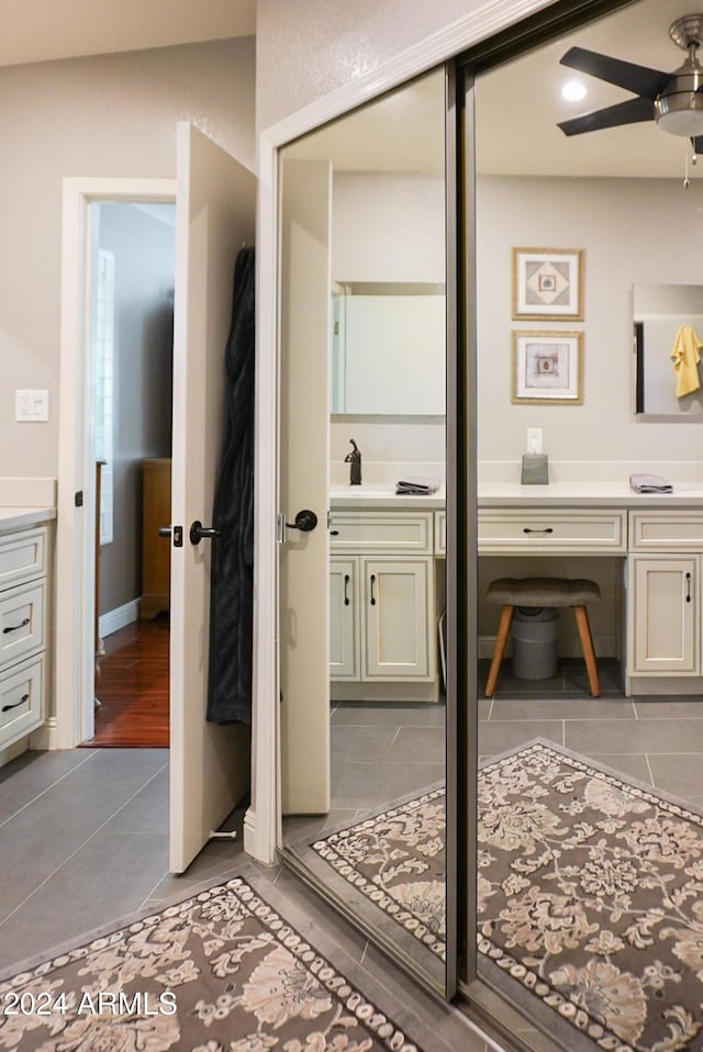 bathroom with tile patterned flooring, vanity, and ceiling fan