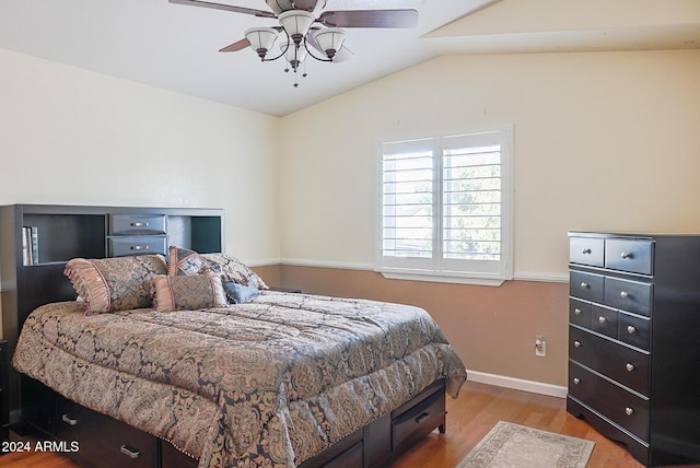 bedroom featuring vaulted ceiling, ceiling fan, and light wood-type flooring