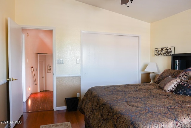 bedroom with hardwood / wood-style flooring and lofted ceiling