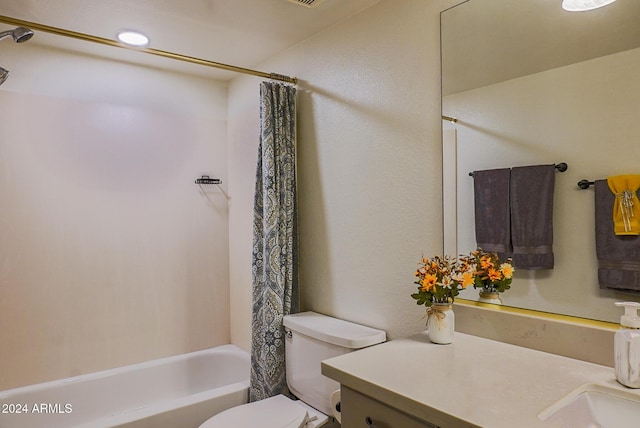 full bathroom with vanity, shower / bath combo, and toilet