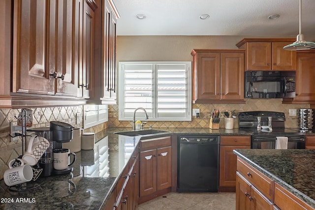 kitchen with pendant lighting, sink, backsplash, black appliances, and dark stone counters