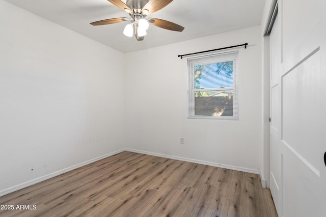 spare room featuring ceiling fan and light hardwood / wood-style floors