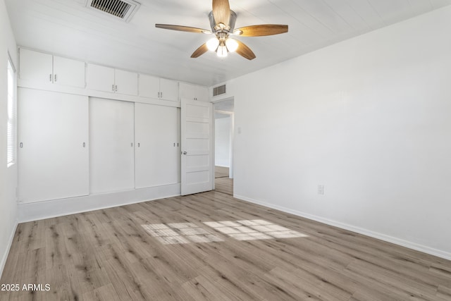 unfurnished bedroom with ceiling fan, a closet, and light hardwood / wood-style floors