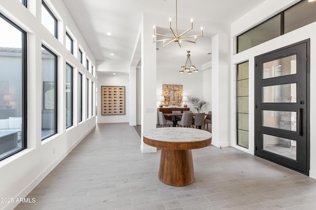 interior space featuring a chandelier and light hardwood / wood-style flooring