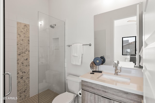 bathroom with vanity, toilet, and a shower with shower door