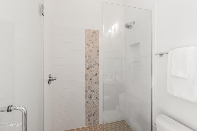 bathroom with an enclosed shower and toilet