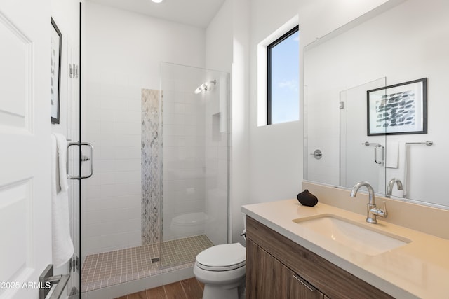 bathroom featuring vanity, hardwood / wood-style floors, toilet, and walk in shower