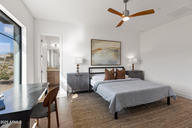 bedroom with ceiling fan, dark hardwood / wood-style floors, and ensuite bath