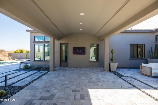 exterior space with a fenced in pool and a patio