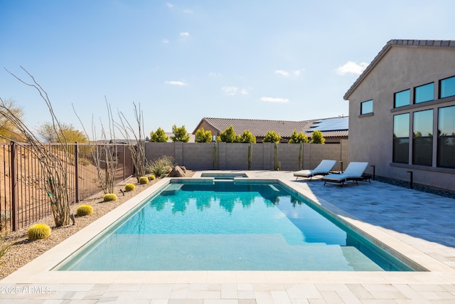 view of pool with an in ground hot tub and a patio