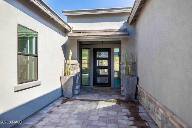 property entrance with a patio area