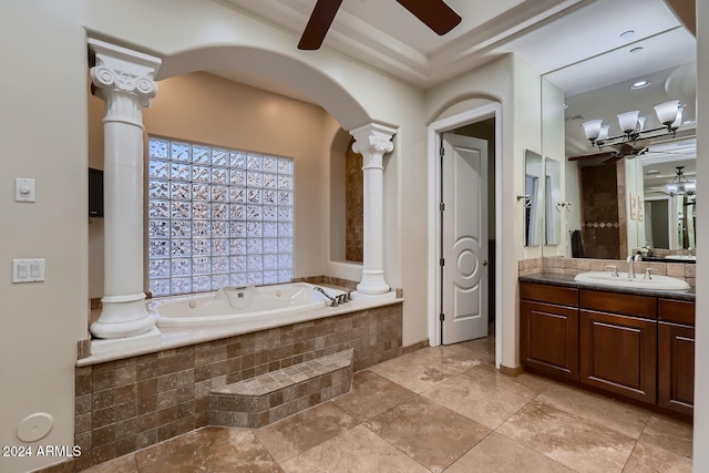 bathroom featuring a relaxing tiled tub, ornate columns, and vanity