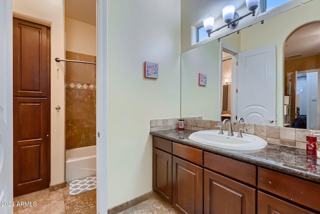 bathroom with vanity, tile patterned floors, and tiled shower / bath