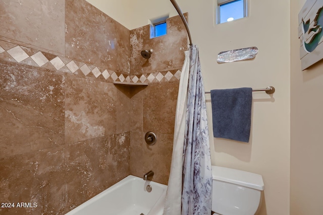 bathroom with toilet and shower / bath combo with shower curtain