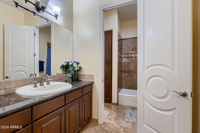 bathroom featuring vanity and tiled shower / bath combo