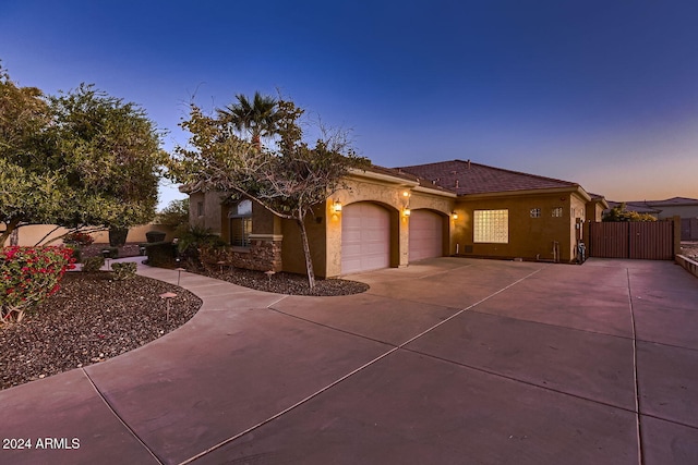 mediterranean / spanish-style home with a garage