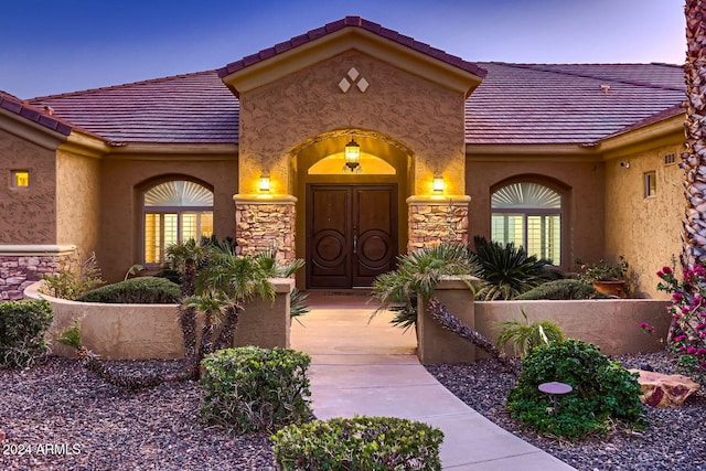 view of exterior entry at dusk