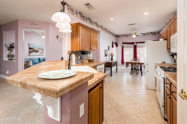 kitchen featuring ceiling fan, pendant lighting, white appliances, and sink