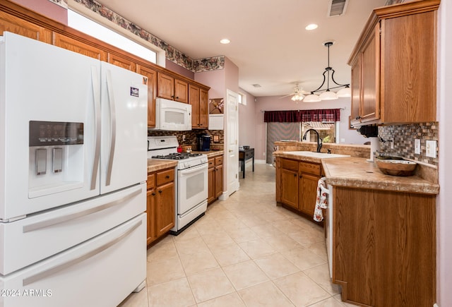 kitchen with decorative light fixtures, tasteful backsplash, white appliances, and sink